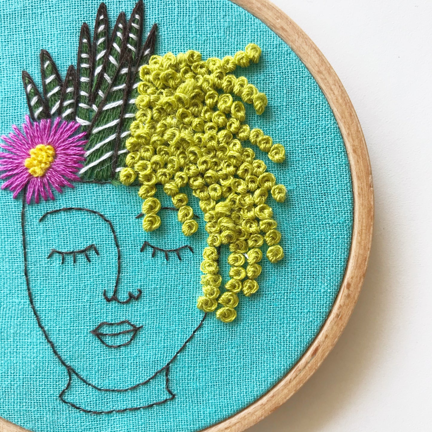 Close up of Zen Zoe Embroidery Kit. Stitch detail of cactus in greens, white and pink.