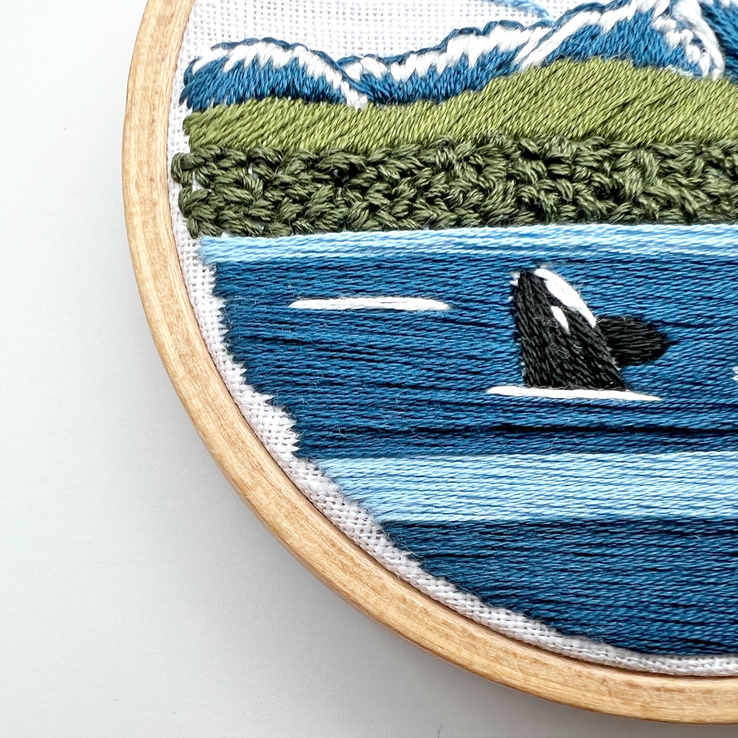 Closeup of Beginner Kit Orcas in the Sound showing stitch detail.