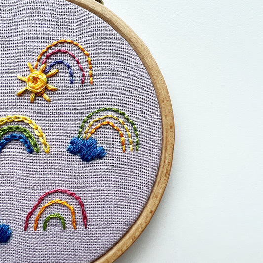 Close up of Sunshine and Rainbows embroidery kit.  As a sampler the kit provides opportunity to practice many stitches.