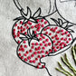 Strawberries on Meet me at the Market tote showing stitch detail of red seeds. Heavy cream canvas with screen printed black outline of strawberries.