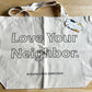 Love Your Neighbor tote is available without the kit. Cream cotton with large open block letters with the words Love Your Neighbor.  Rosanna Diggs Embroidery is in small capital letters at the bottom edge of bag.