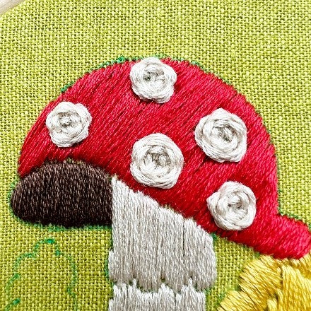 Close up of mushroom details for The Fungis.   PDF Pattern Download   is a 12 page pdf that walks you through everything you need to know to stitch this beautiful embroidery.