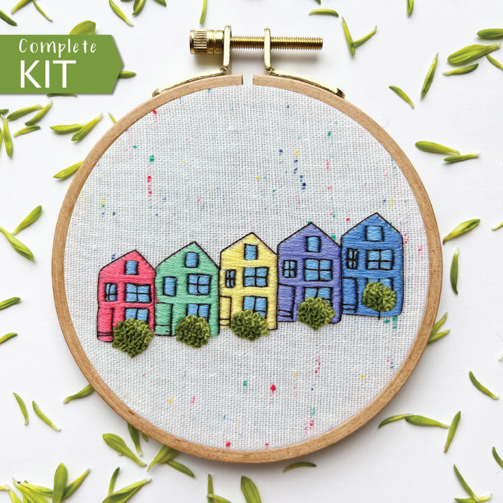 Painted Ladies Complete Embroidery Kit.  5 homes in red, green, yellow, purple and blue with shrubs in front.  Reminiscent of San Francisco's Victorian homes on Steiner Street.