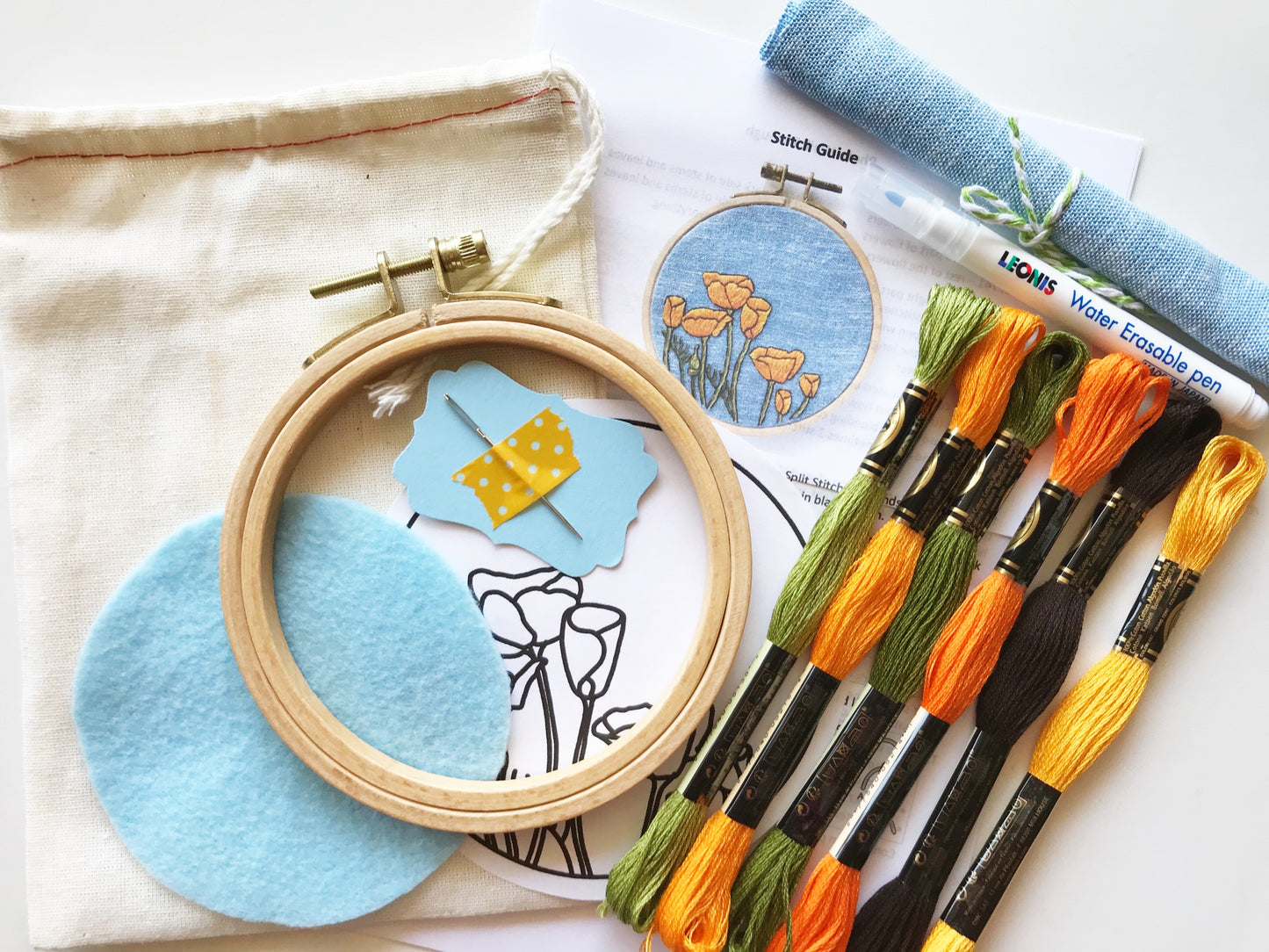 You will need: 4 inch wooden hoop, 6 inch square linen fabric, water soluble pen, 6 strand embroidery floss, needle, felt for backing, pattern, step-by-step instructions