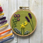 Family Flower Garden Embroidery Kit on green fabric